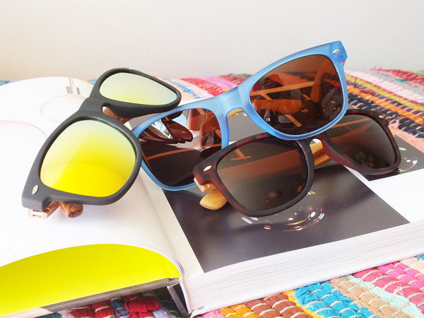 Group of sunglasses in different colour combinations, all with wooden arms